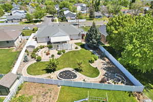 Expansive backyard featuring a manicured lawn, established landscaping, and decorative stone pathways