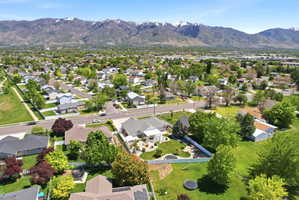 Expansive residential neighborhood with mature trees and mountain backdrop