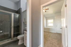 Bathroom featuring a glass-enclosed shower with tile surround, a mosaic accent band, and a built-in shower niche