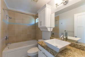 Bathroom featuring a soaking tub with subway tile surround and decorative accent band
