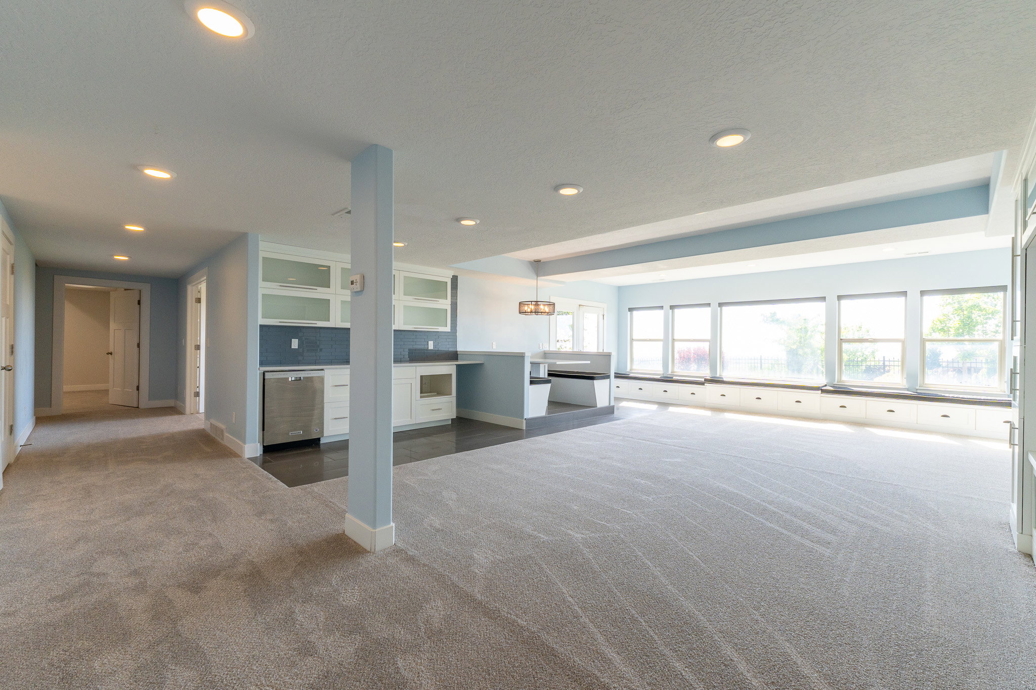 Open-concept living area featuring light gray carpeting and recessed lighting