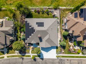 Contemporary residential property featuring a multi-gabled roofline and solar panel installation