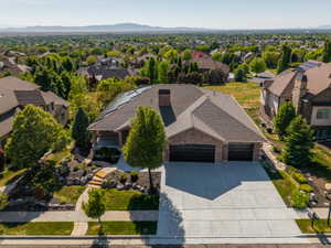 Brick exterior home featuring a multi-car garage, concrete driveway, and stepped stone pathway
