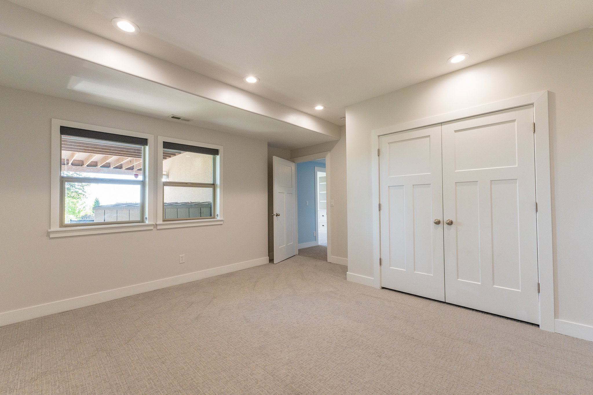 Spacious room featuring neutral carpeting and recessed lighting