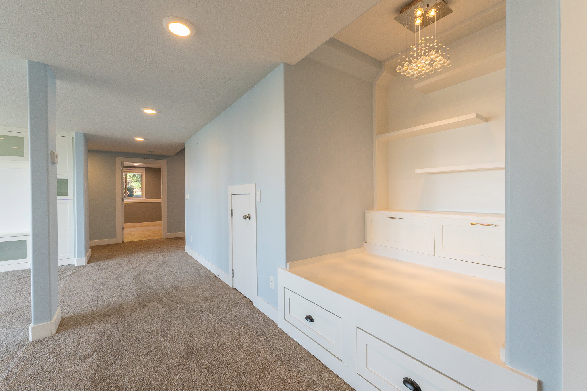 Built-in seating with integrated storage drawers and floating shelves