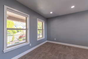 Light gray walls complement the neutral tone carpet flooring
