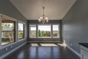 Spacious room featuring gray walls and large-format tile flooring