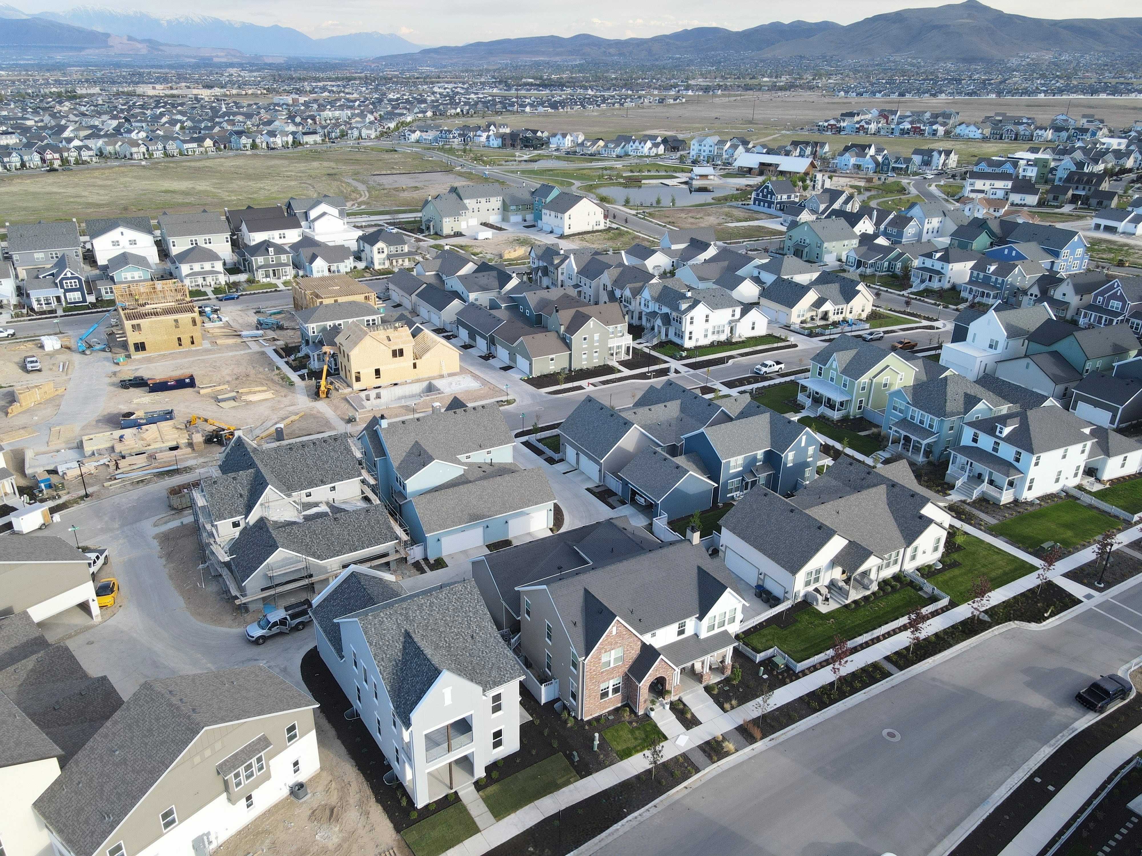 Aerial of home and community featuring varied architectural styles and landscaping