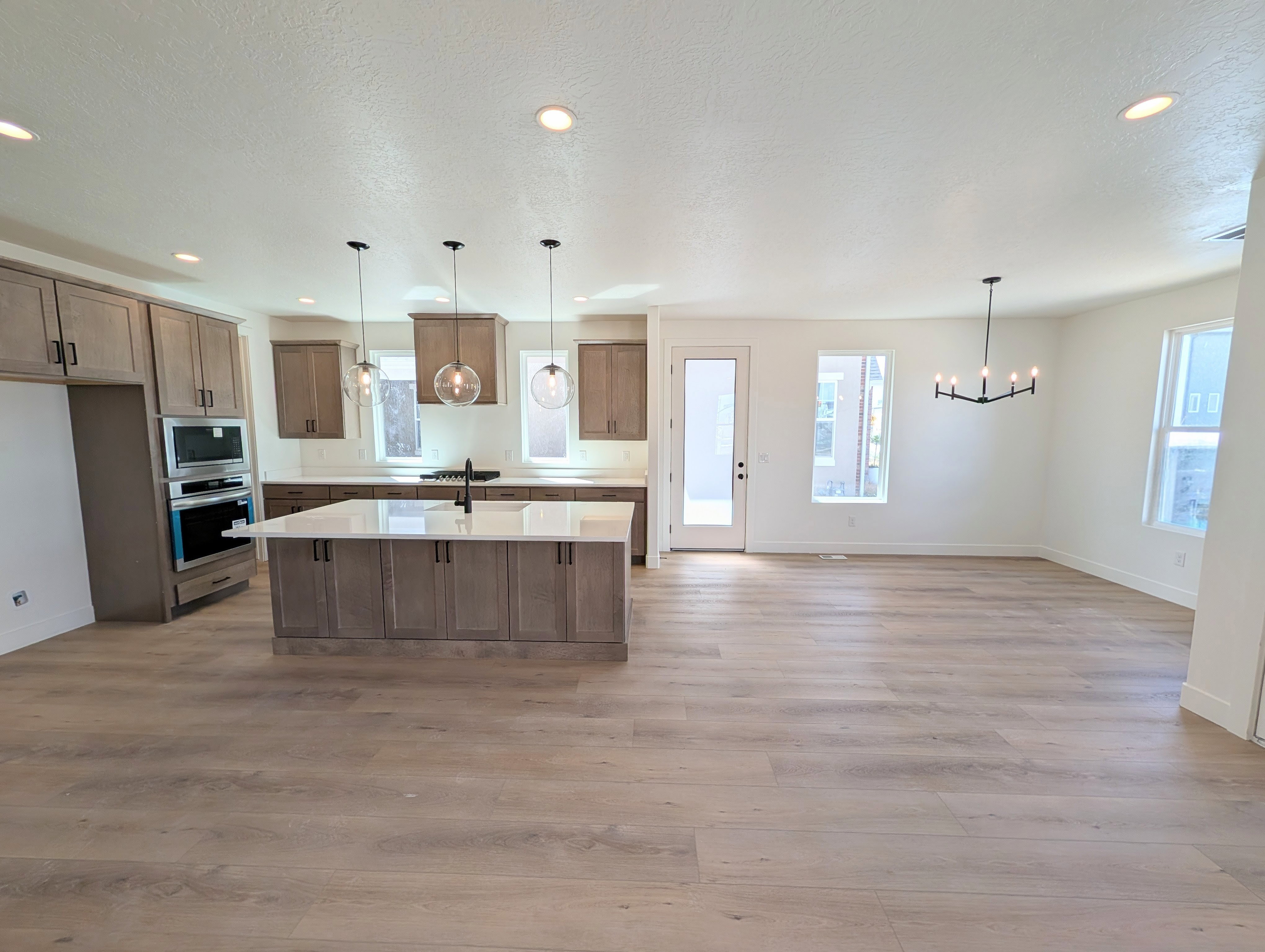 Open-concept living space with wood-finish flooring throughout