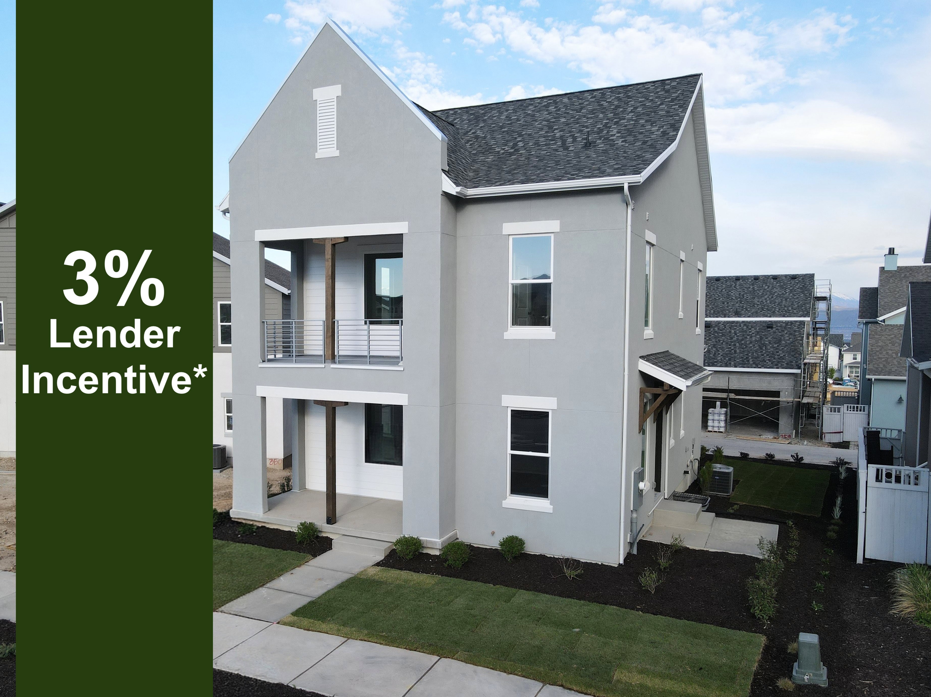 Modern stucco exterior with white trim windows and dark shingle roofing