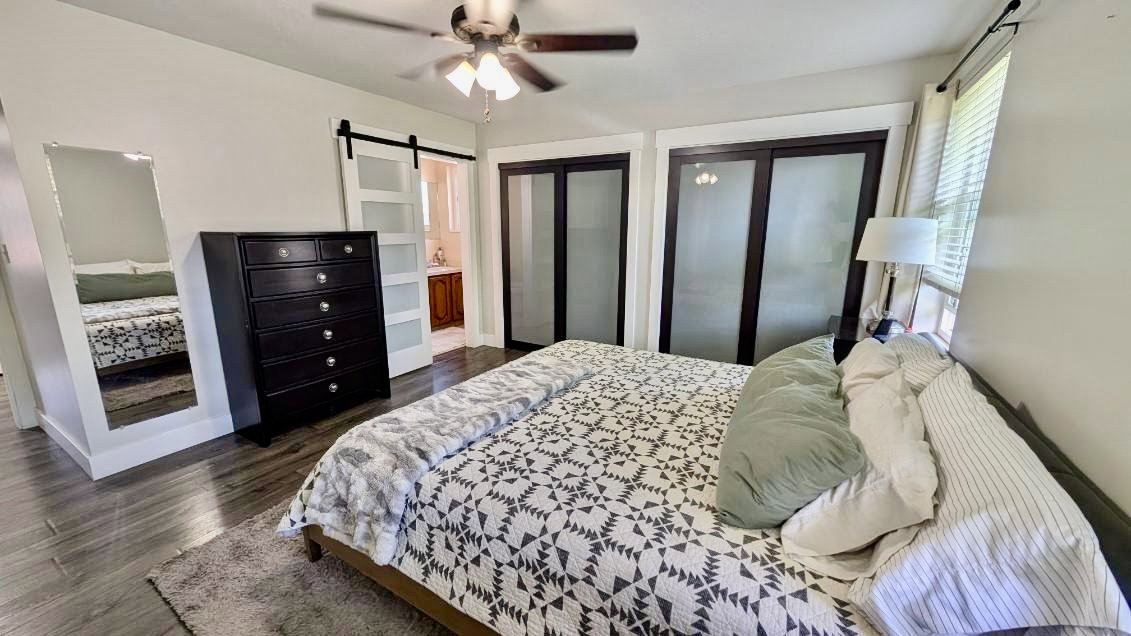 Wood-finish flooring throughout, featuring a ceiling fan with integrated lighting