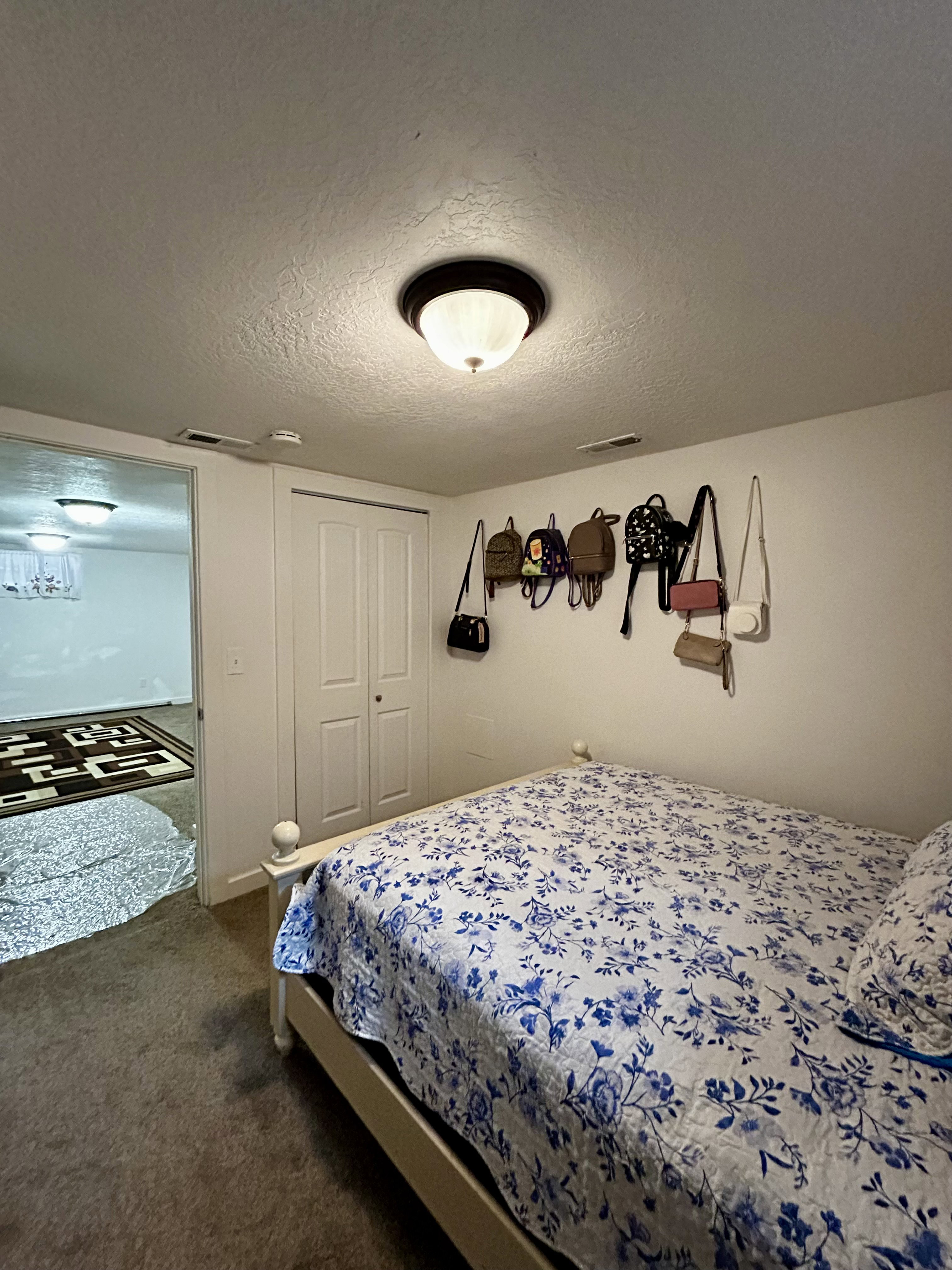 Bedroom #3 featuring wall-to-wall carpeting, bi-fold closet doors, and an overhead flush mount light fixture