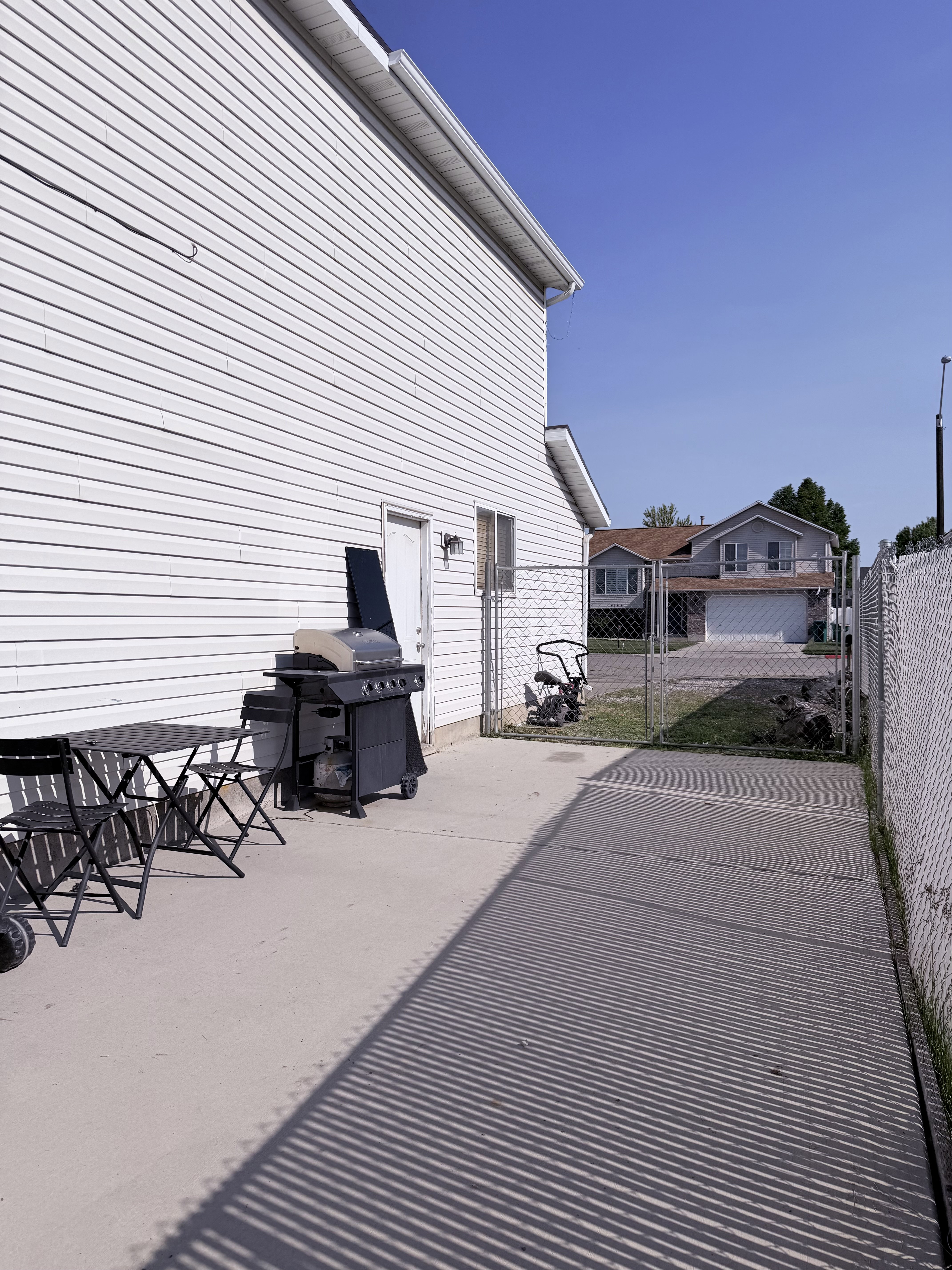 Rear exterior featuring white vinyl siding