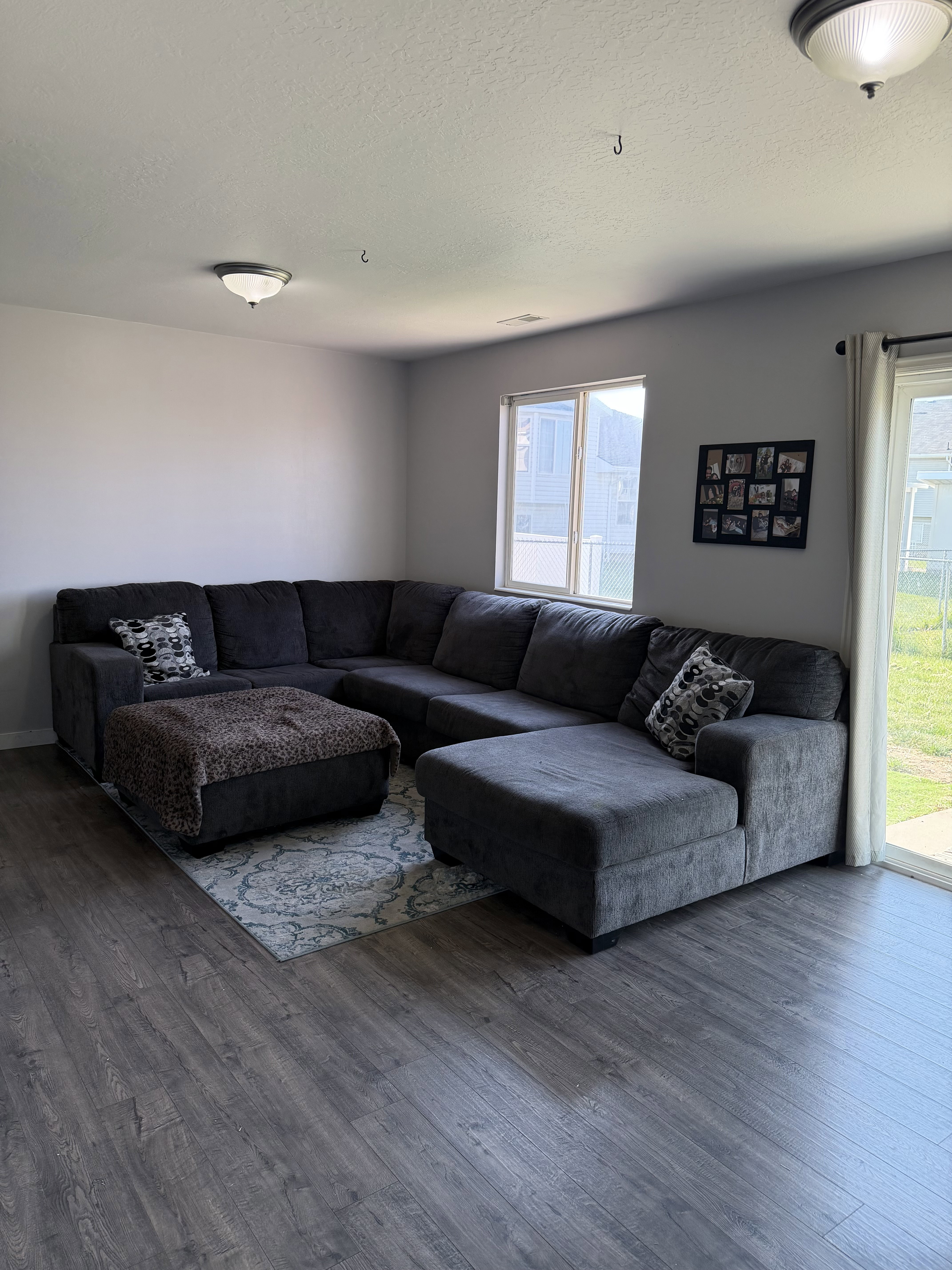 Spacious living area featuring wood-finish flooring, neutral wall tones, and recessed lighting