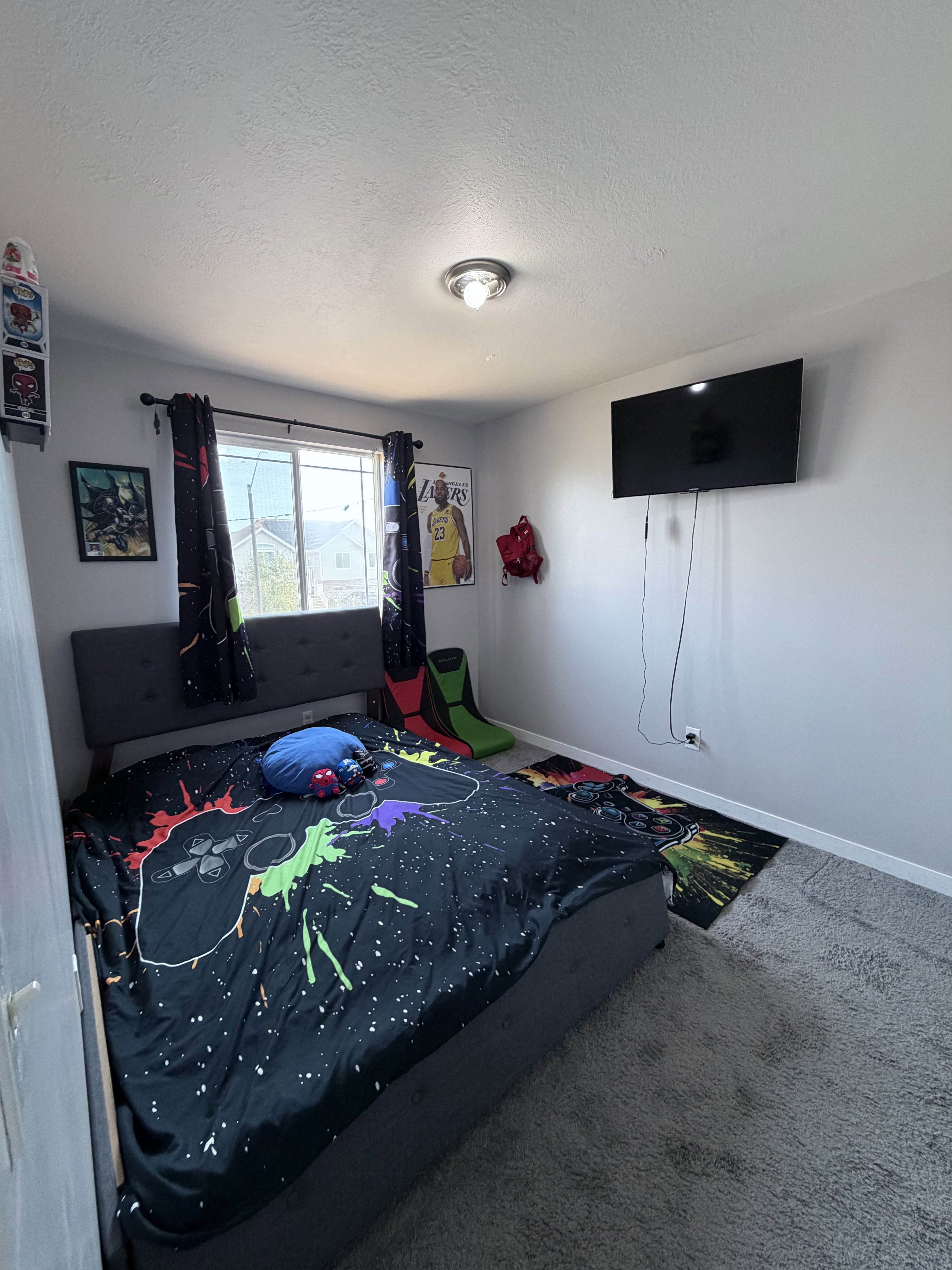 Carpeted room featuring a double window with dark drapery panels, light gray wall paint, and a flush mount ceiling light fixture