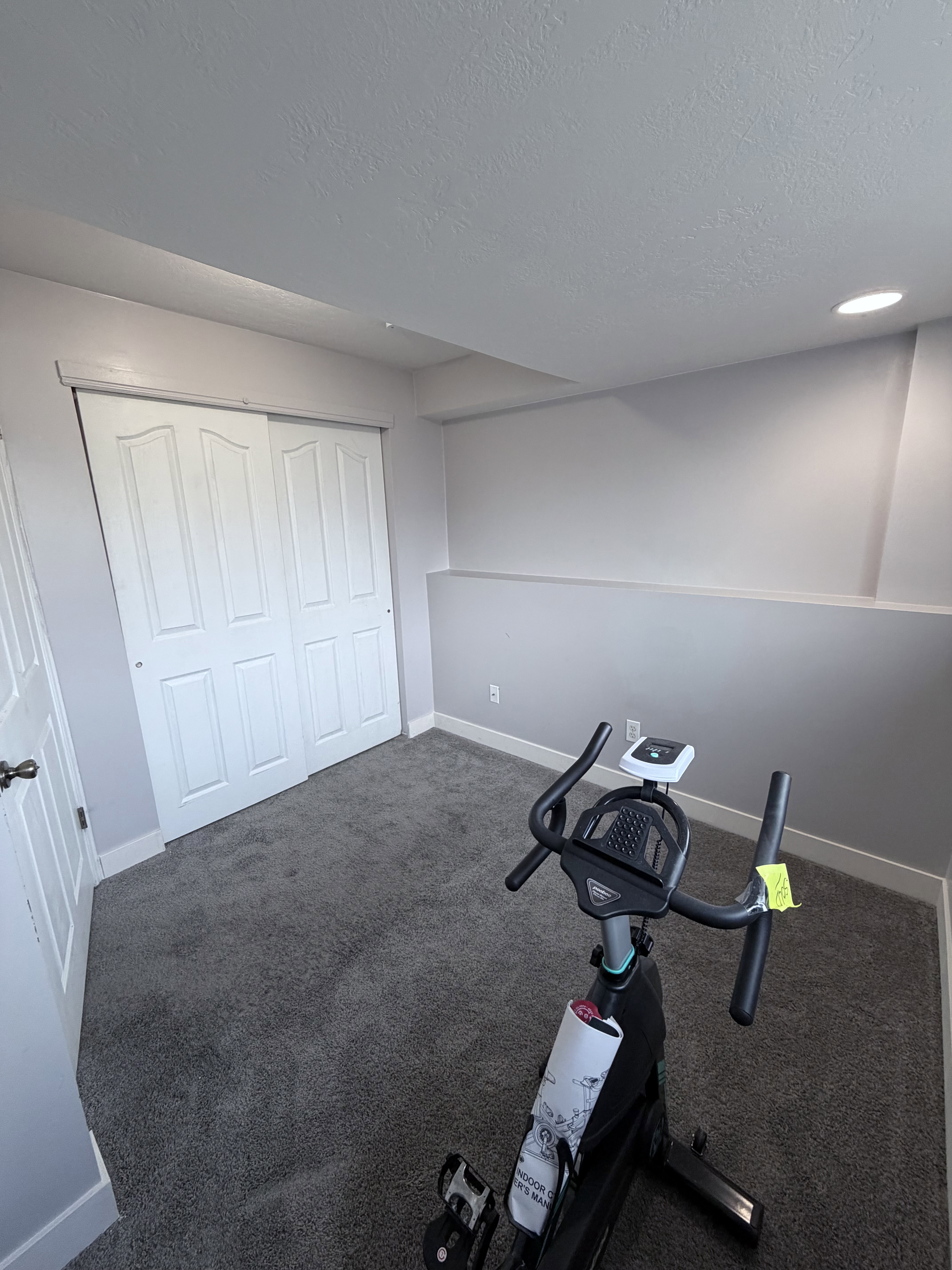 Carpeted room featuring a double bi-fold closet and recessed lighting