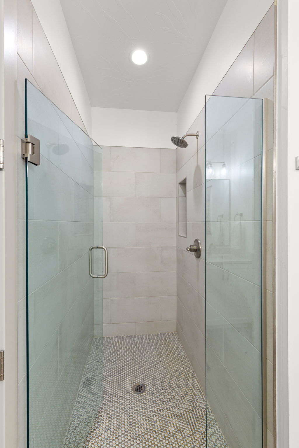 Walk-in shower with clear glass enclosure
