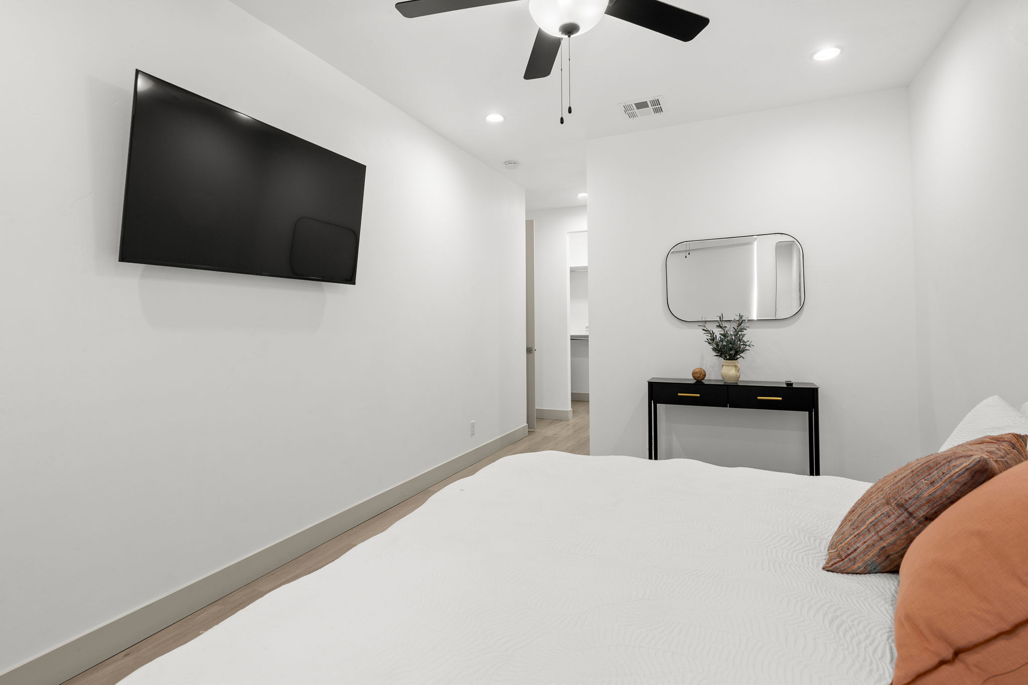 Bright interior space featuring recessed lighting, a ceiling fan, wood-finish flooring, and white baseboards