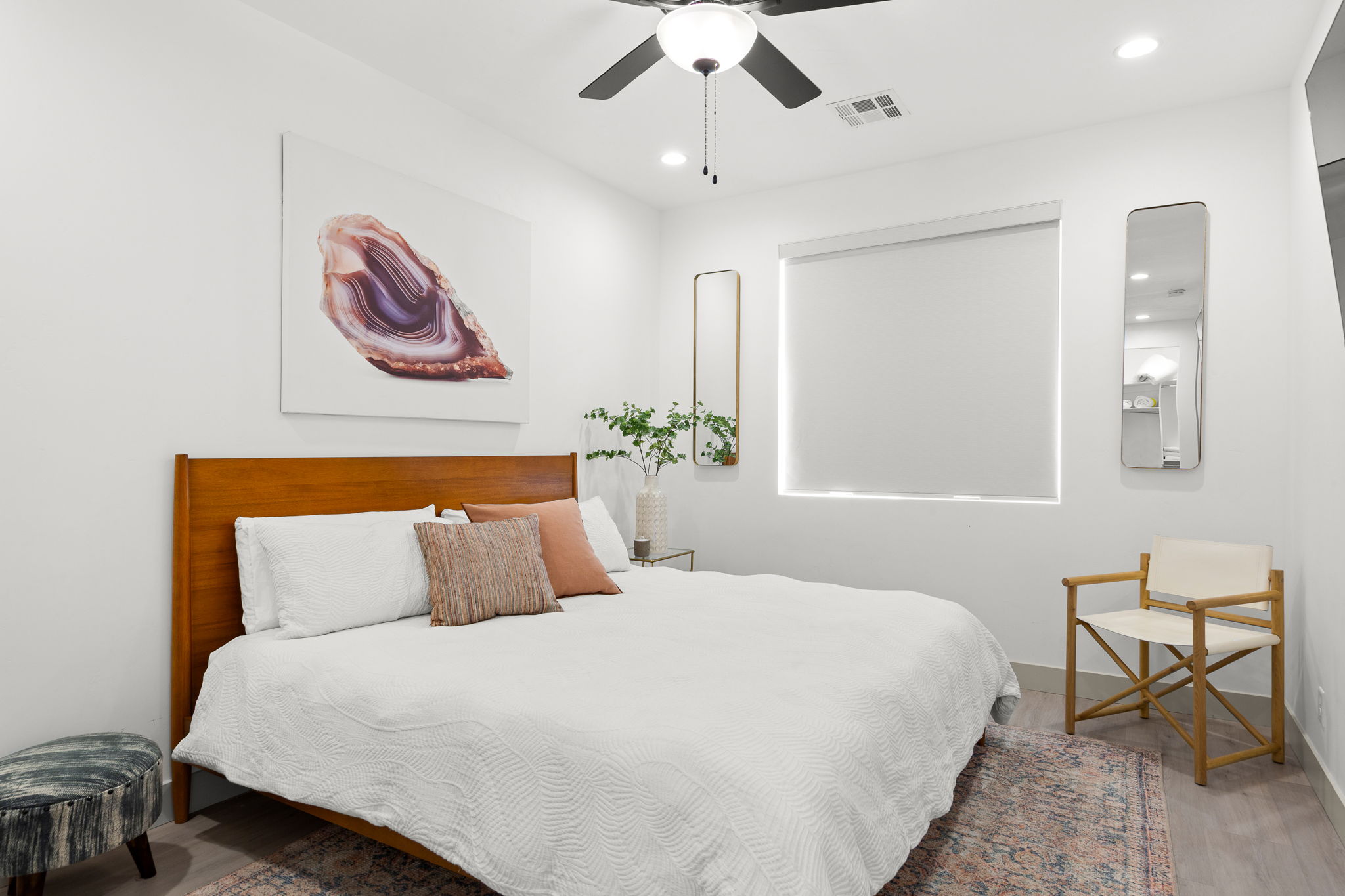 Bedroom featuring recessed lighting, a ceiling fan, a window with a roller shade, wood-finish flooring, and white walls