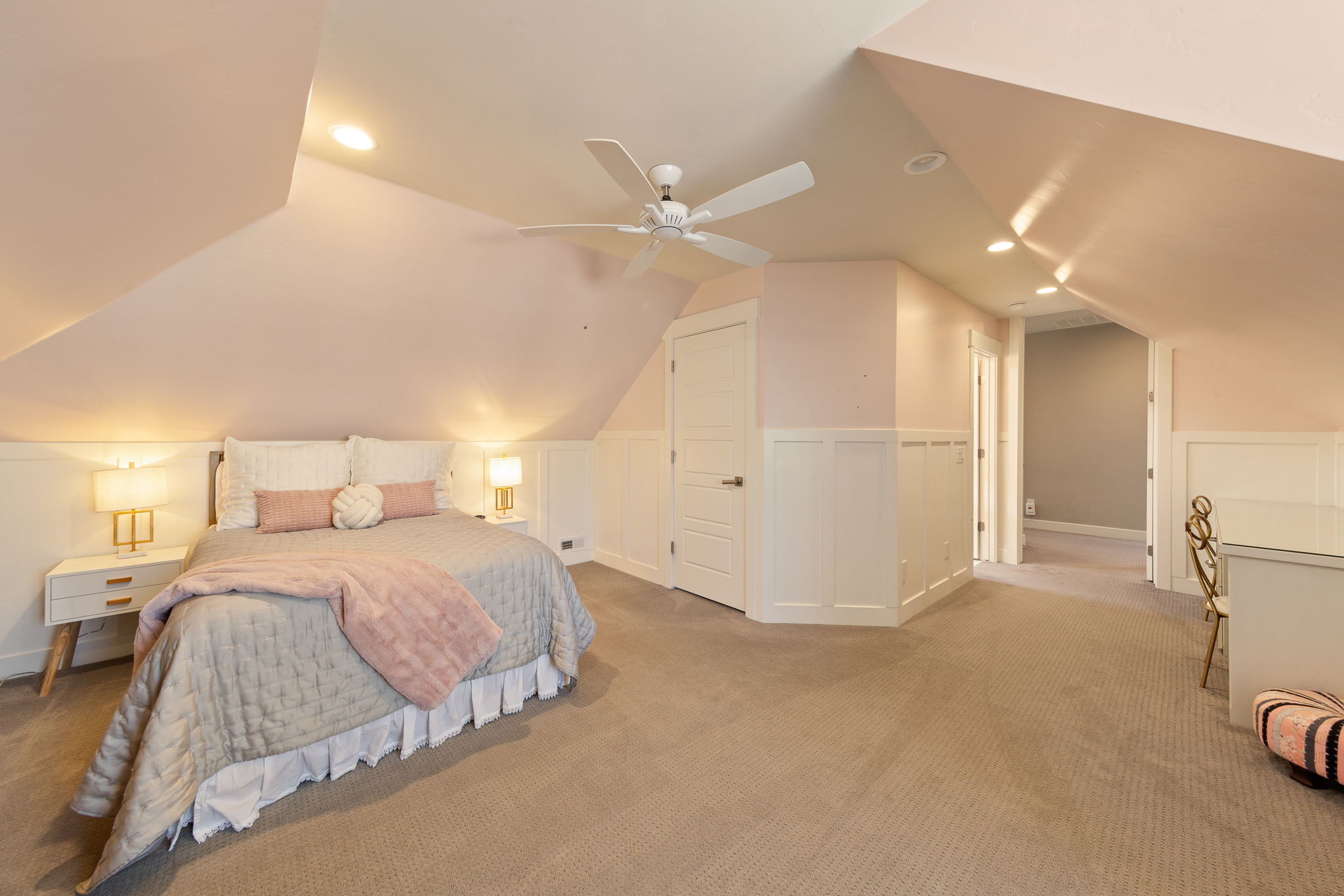 Room featuring sloped ceilings, recessed lighting, a ceiling fan, wainscoting, and carpet flooring