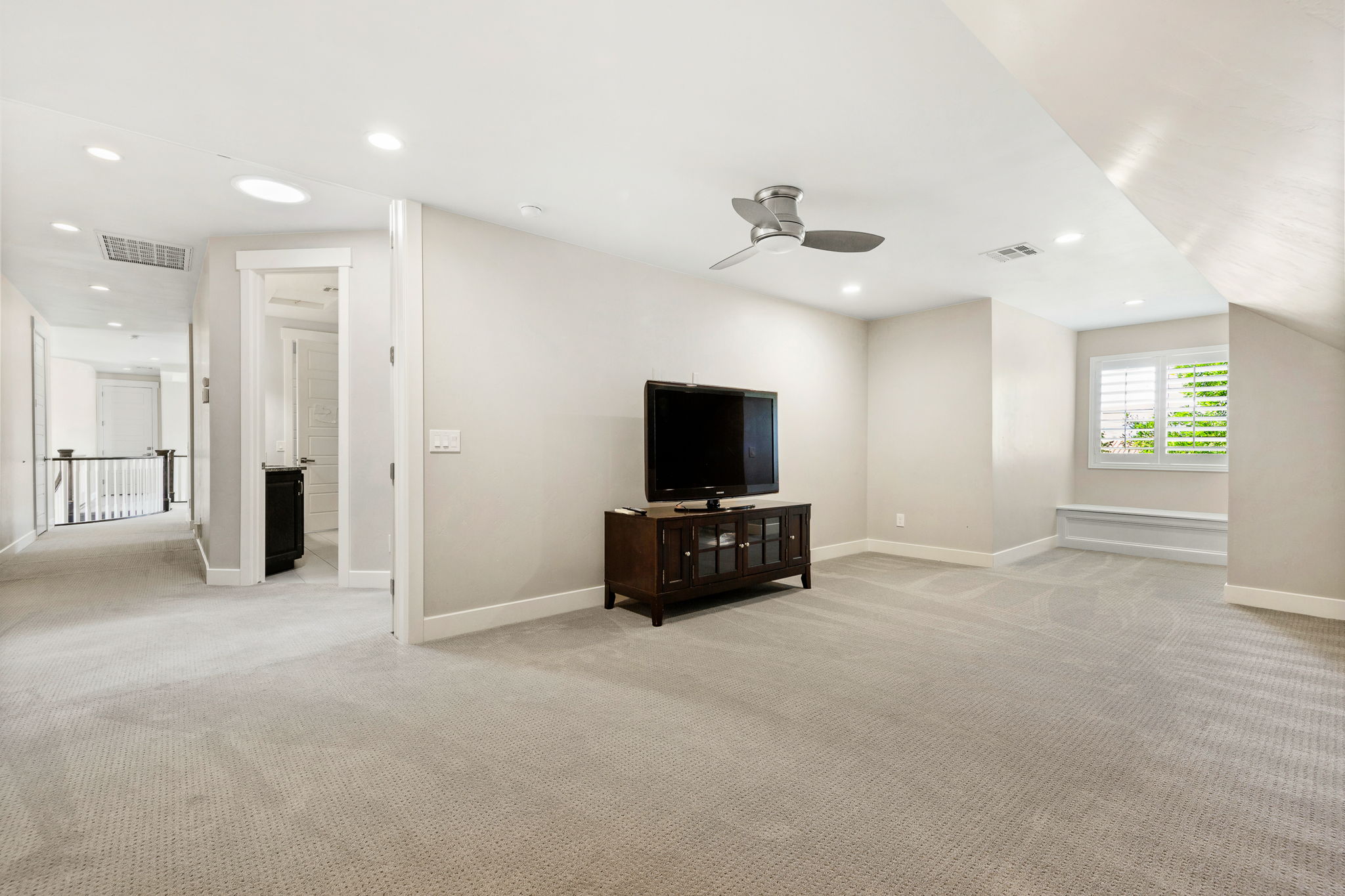 Open concept bonus room featuring light-toned carpeting, recessed lighting, and a modern ceiling fan