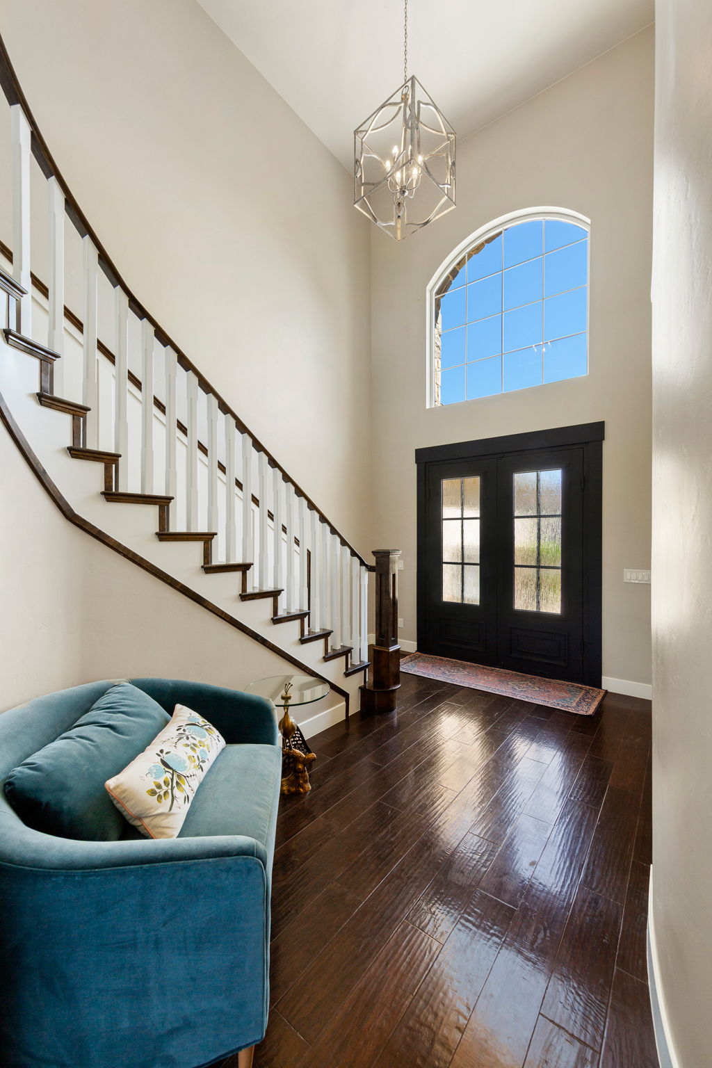 Grand entryway with a soaring ceiling and wood-finish flooring