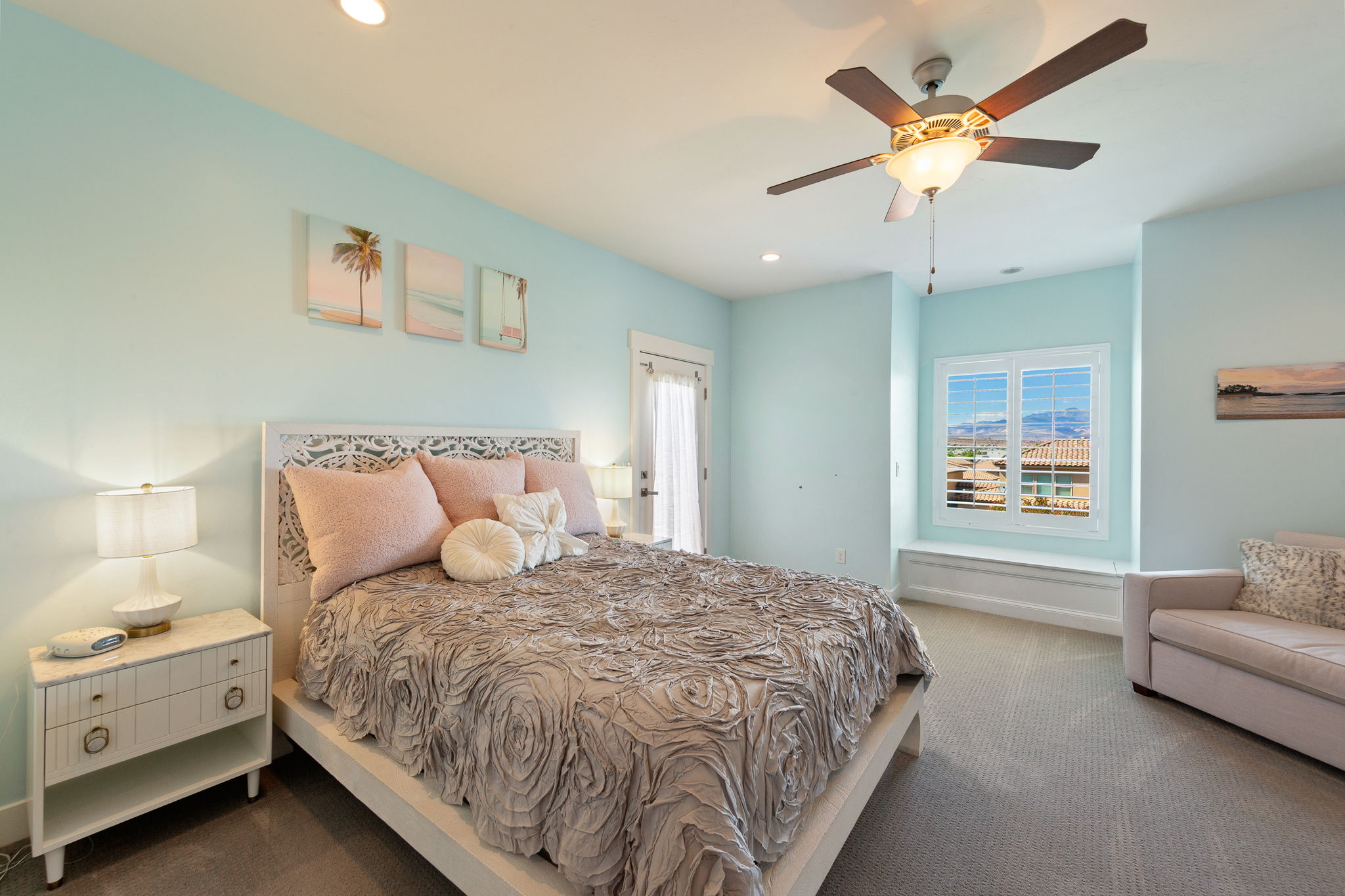 Bright room featuring light blue walls and neutral carpet flooring