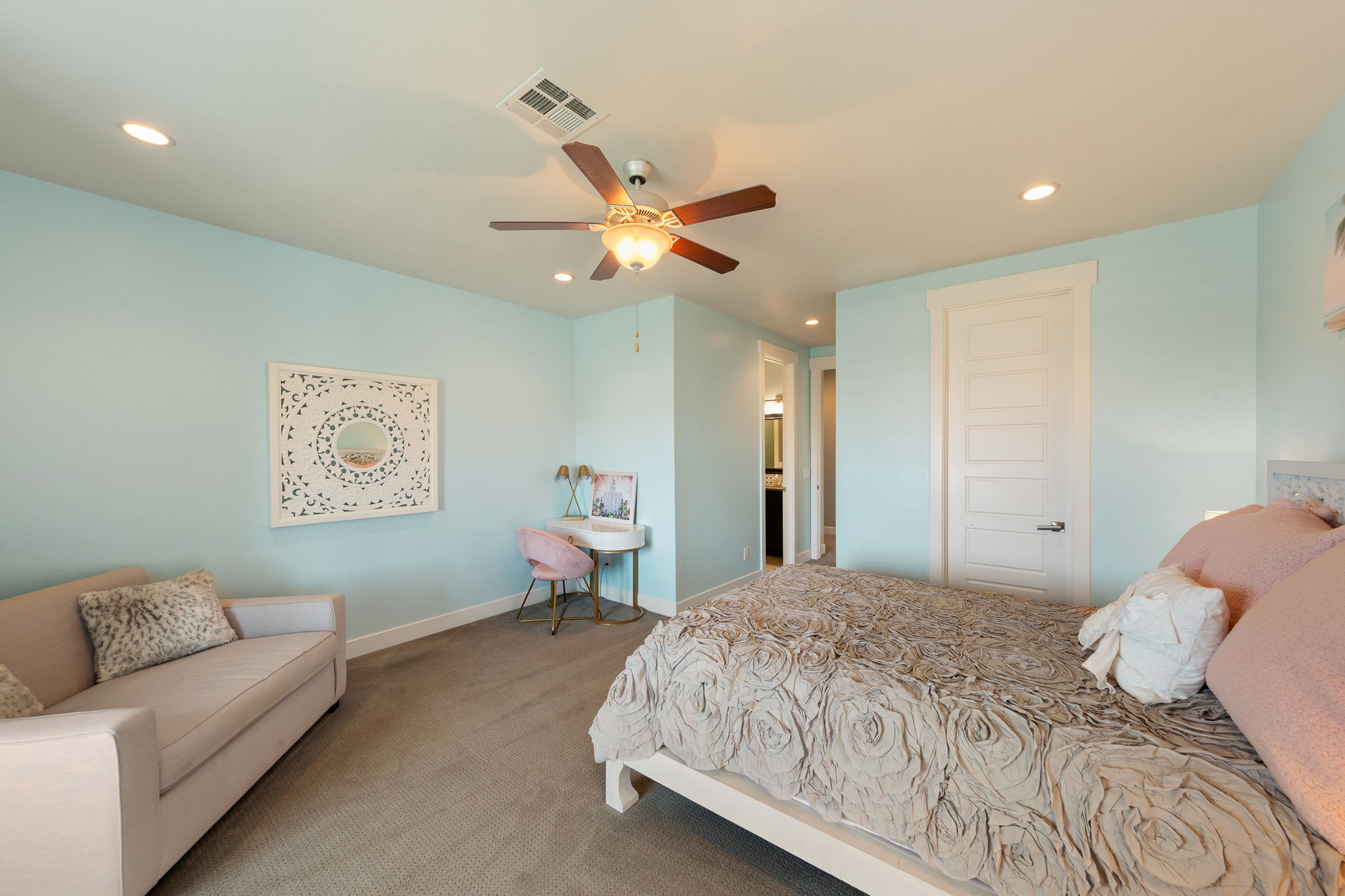 Carpeted bedroom with a ceiling fan, recessed lighting, and a five-panel interior door