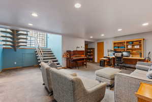 Spacious lower level featuring recessed lighting, carpeted flooring, and a built-in wall unit with shelving