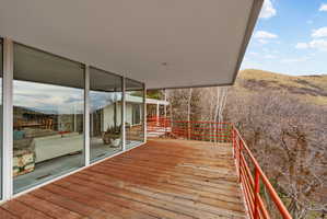 Expansive wood-plank deck with a vibrant orange railing