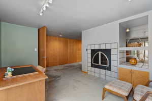 Integrated storage wall with wood-finish cabinetry and drawers