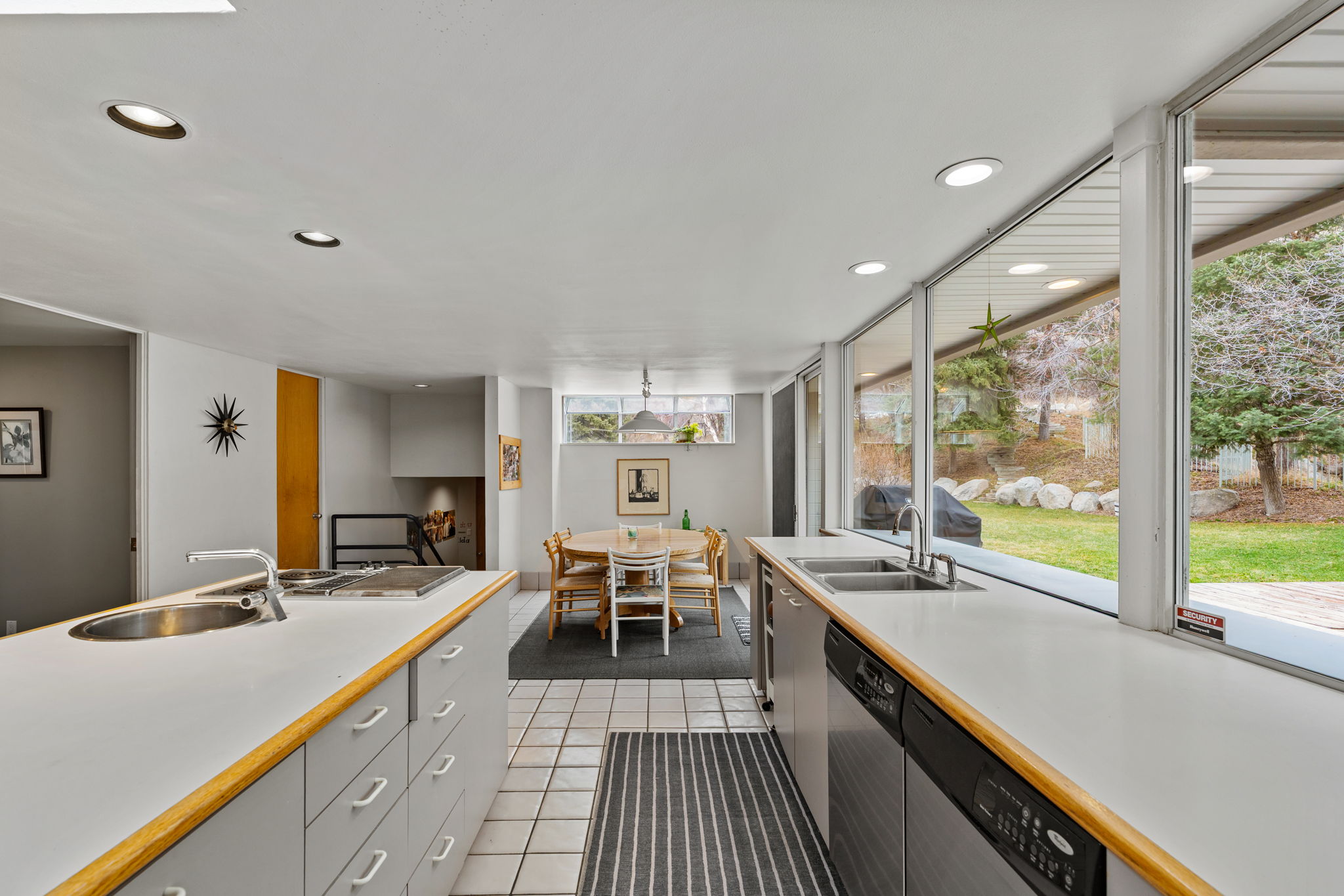 Kitchen featuring a dual-basin sink, built-in cooktop, and extensive counter space