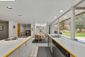 Kitchen featuring a dual-basin sink, built-in cooktop, and extensive counter space