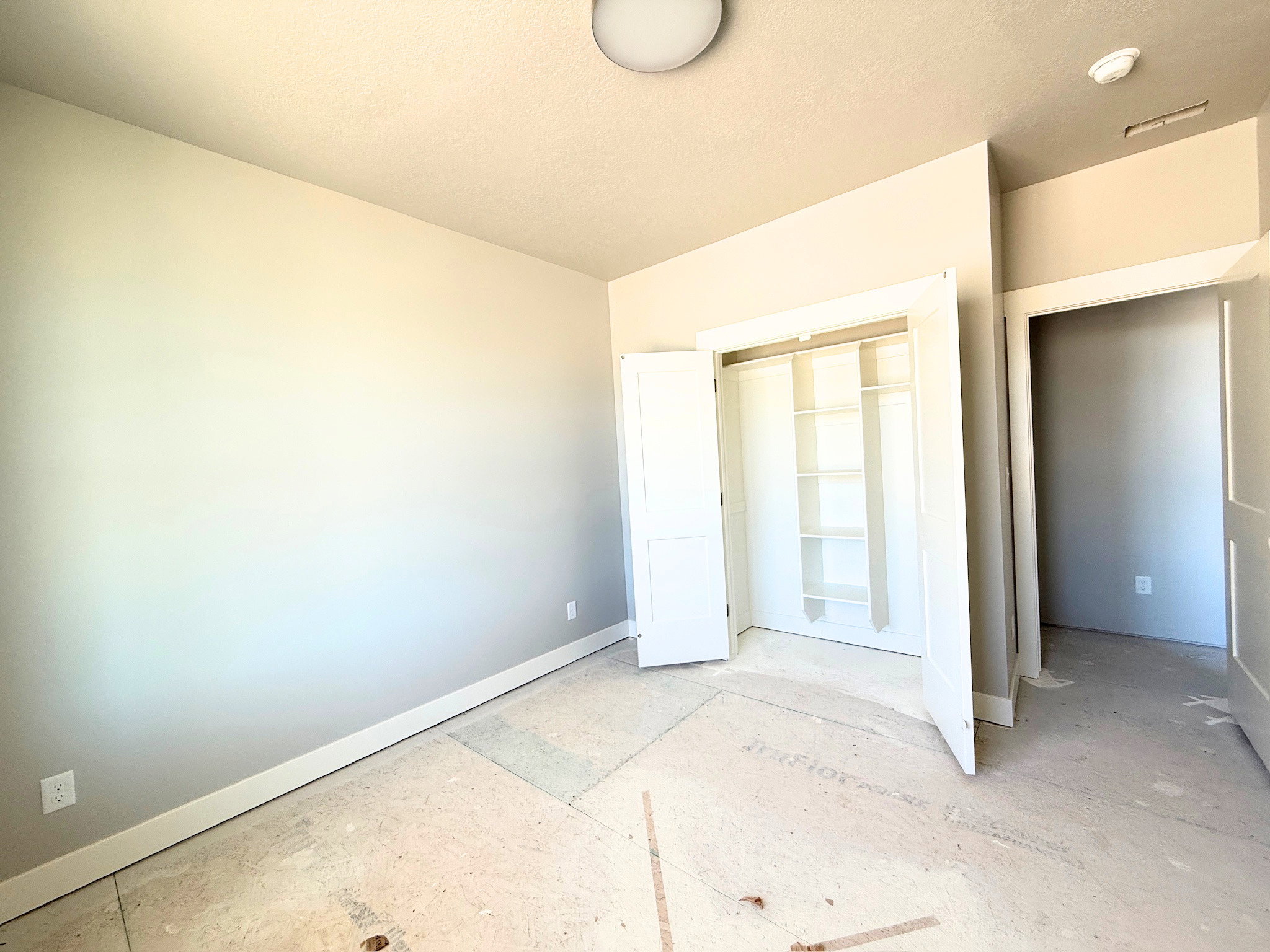 Interior room featuring light neutral wall paint, white trim, and a flush-mount ceiling light
