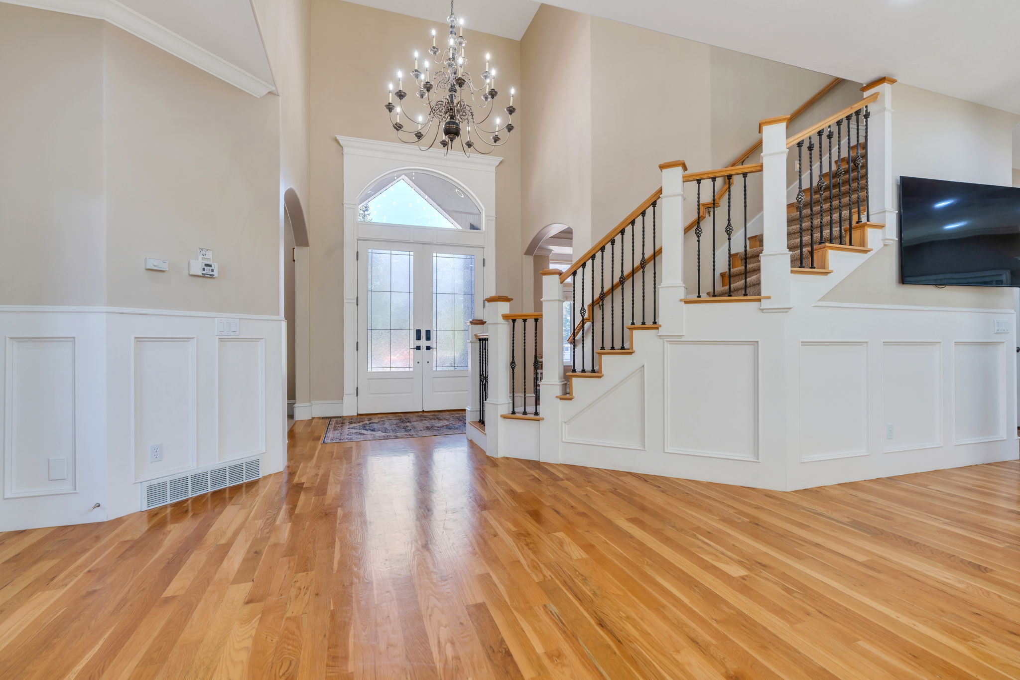Double-door entry with arched transom and sidelights