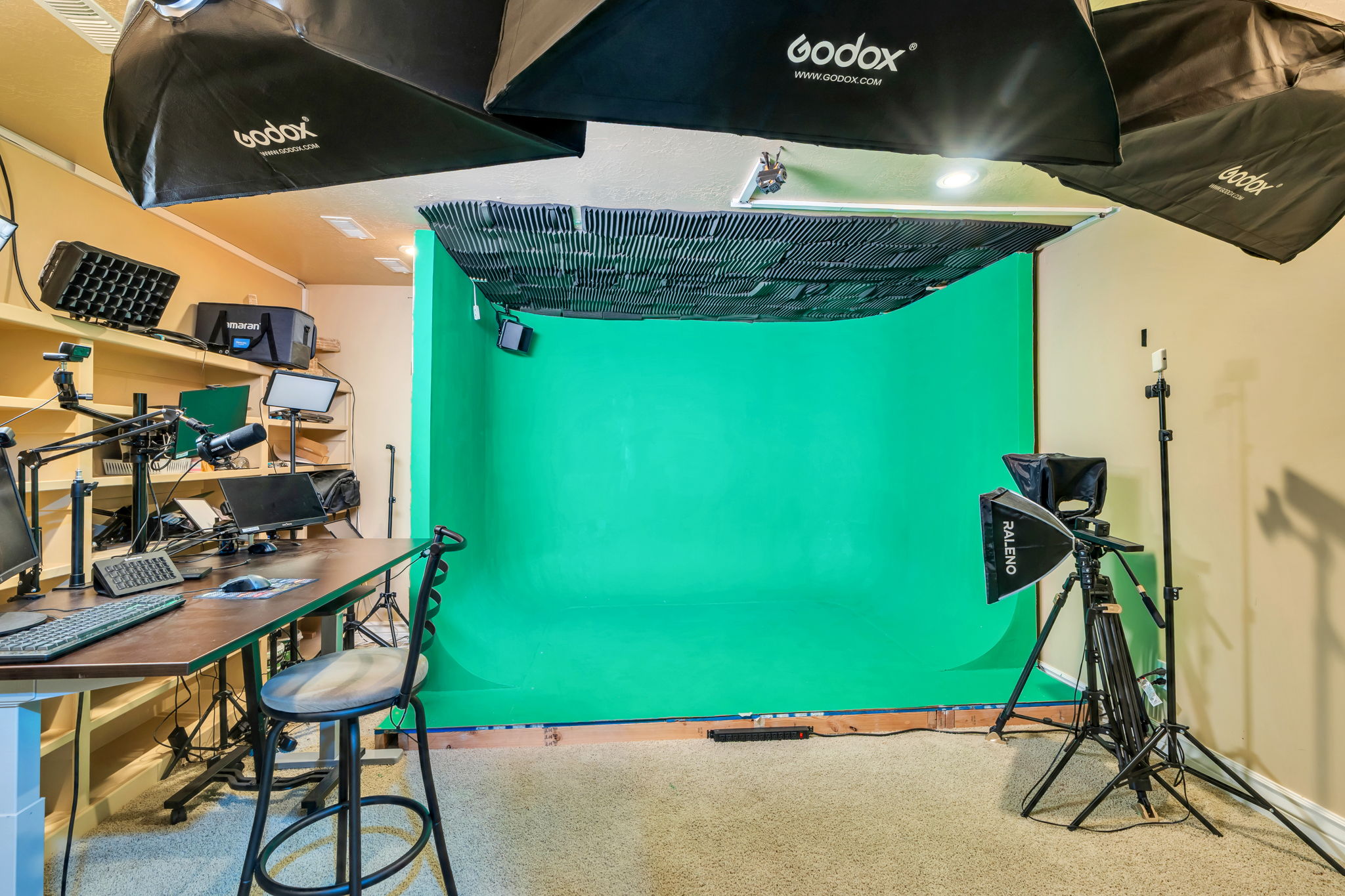 Dedicated studio space featuring a large green screen backdrop and sound-dampening ceiling panels