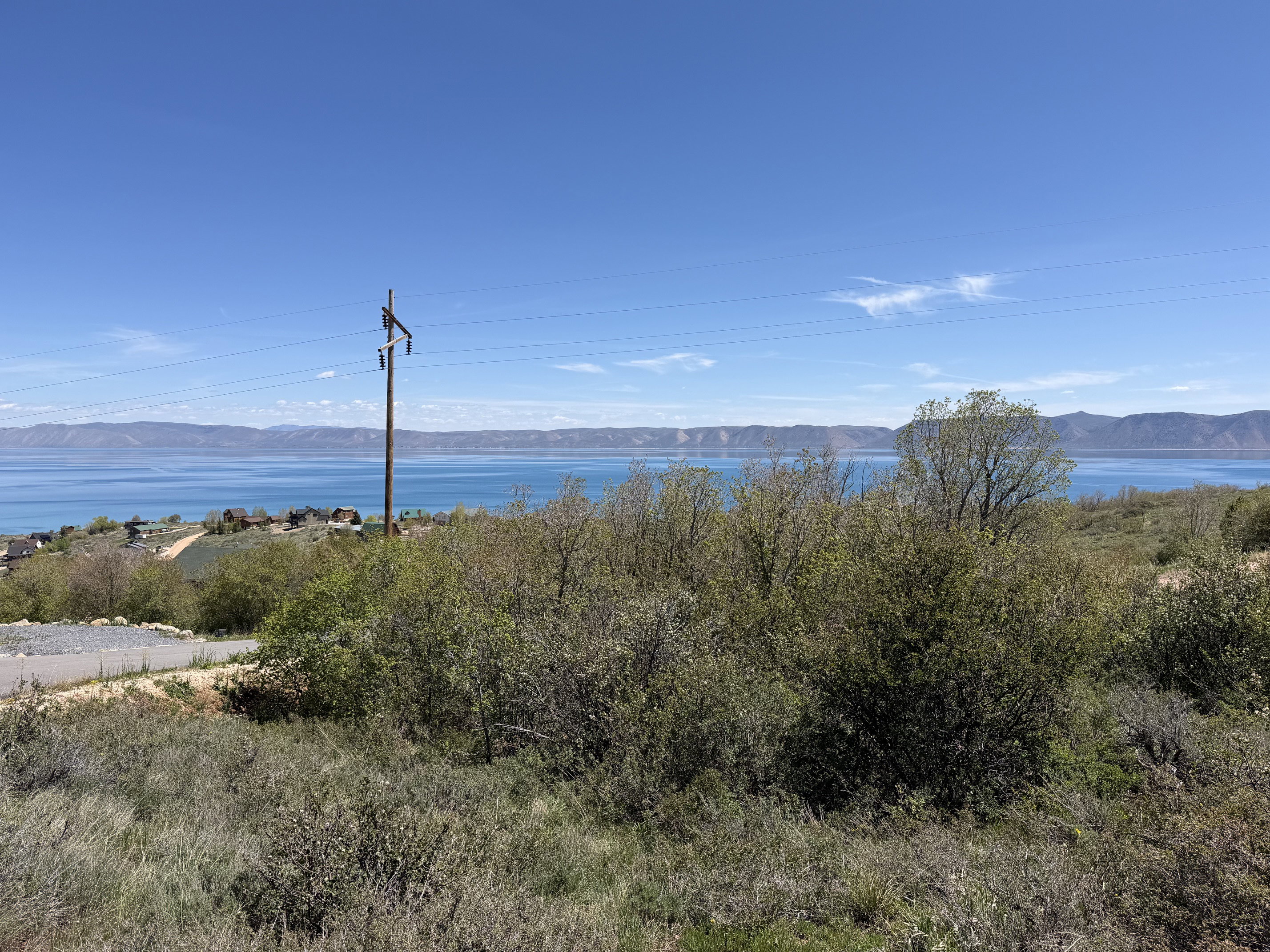 Expansive terrain with distant water and mountain scenery