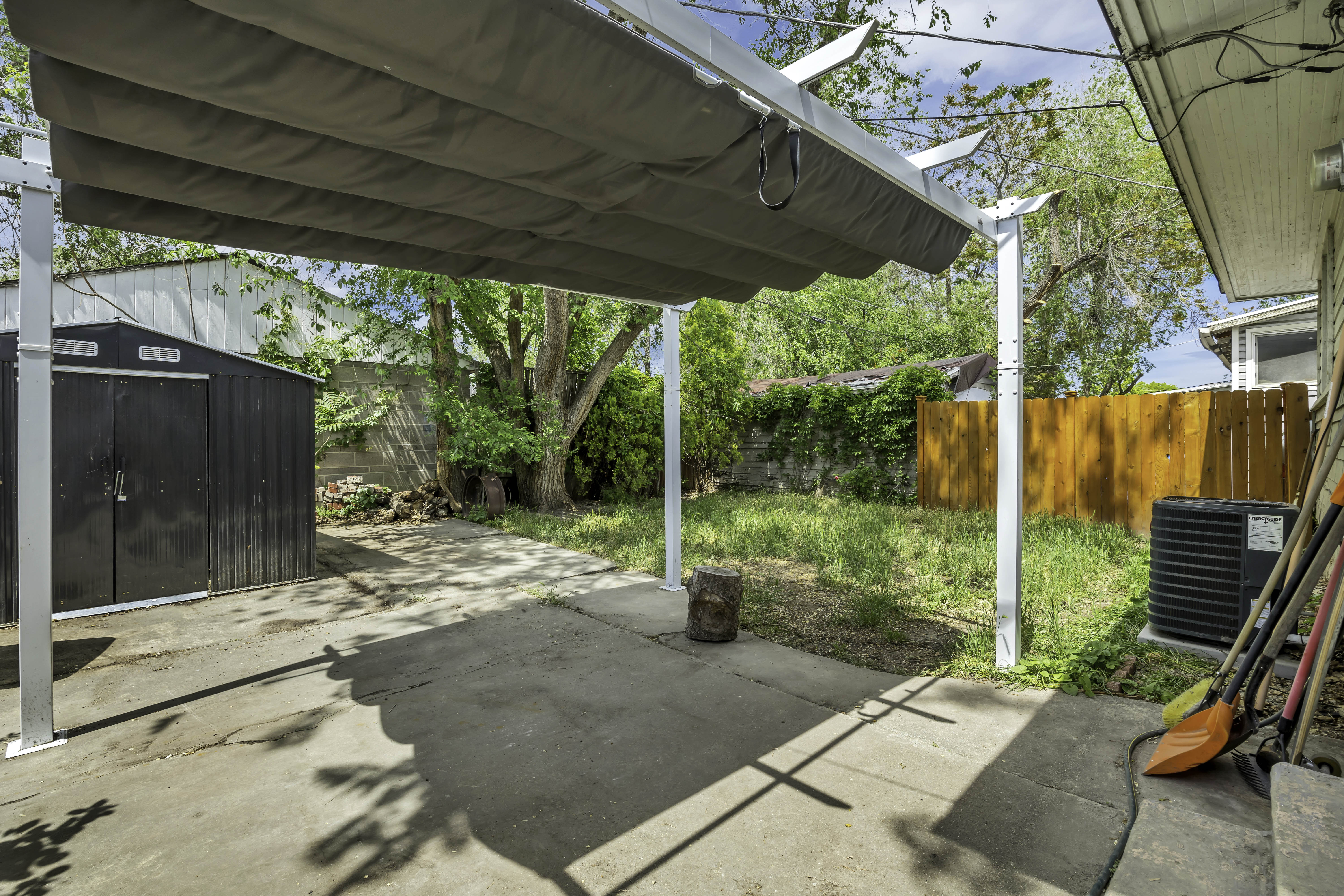 Concrete patio featuring a retractable awning