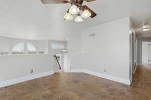 Spacious upper-level landing featuring durable tile-look flooring, a ceiling fan with integrated lighting, and a partial wall overlooking the lower level