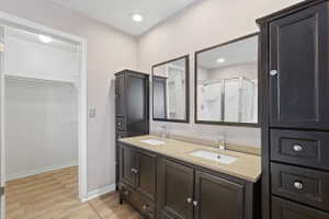Double vanity with undermount sinks, chrome faucets, and light-toned countertop