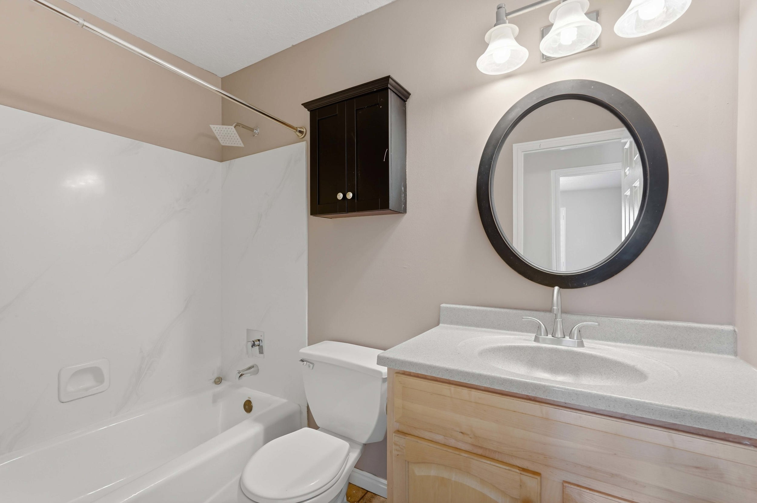 Bathroom featuring a vanity with a light-toned countertop, an integrated sink, and brushed nickel fixtures