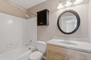 Bathroom featuring a vanity with a light-toned countertop, an integrated sink, and brushed nickel fixtures