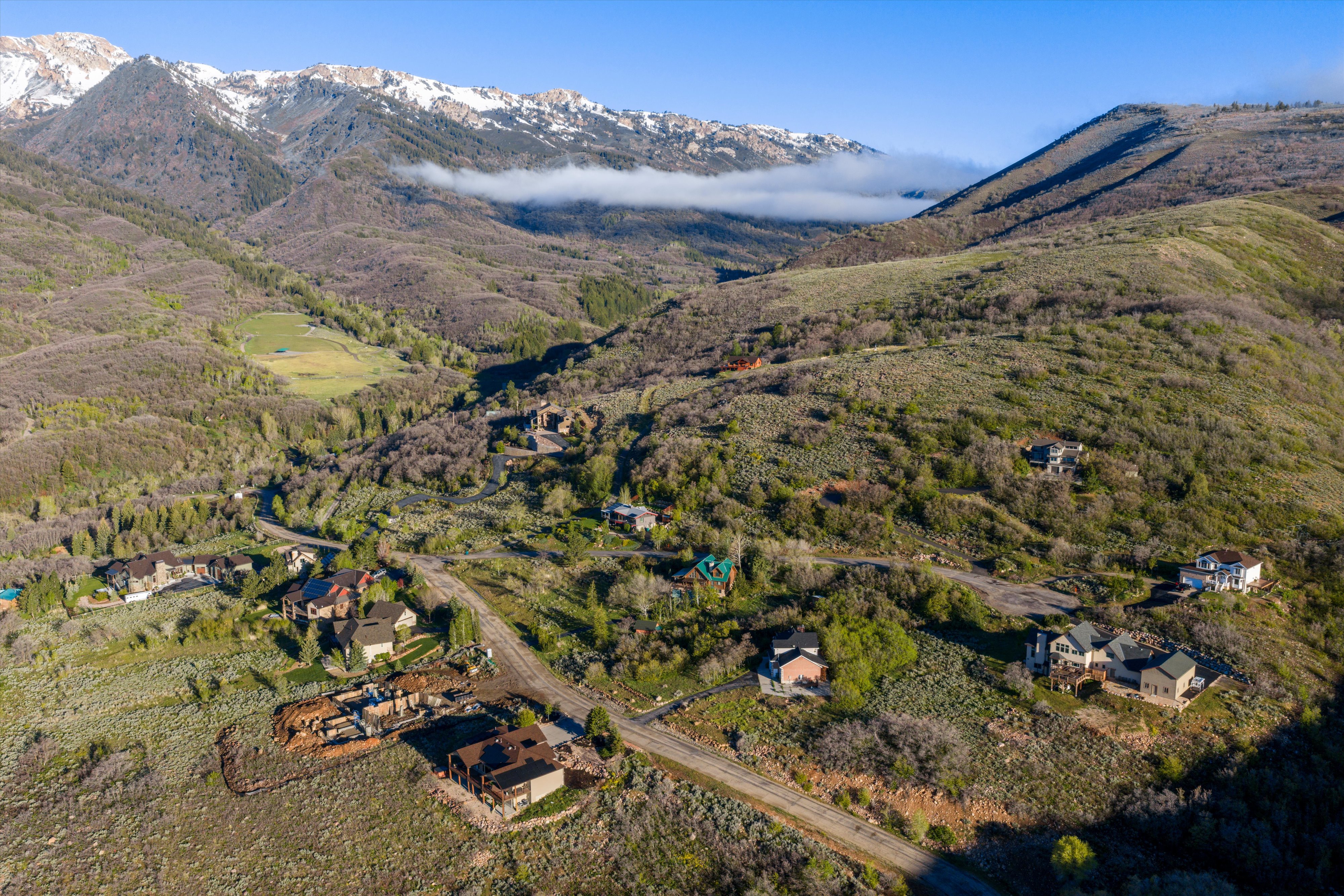 Aerial mountain community showcasing multiple residential structures and winding roads