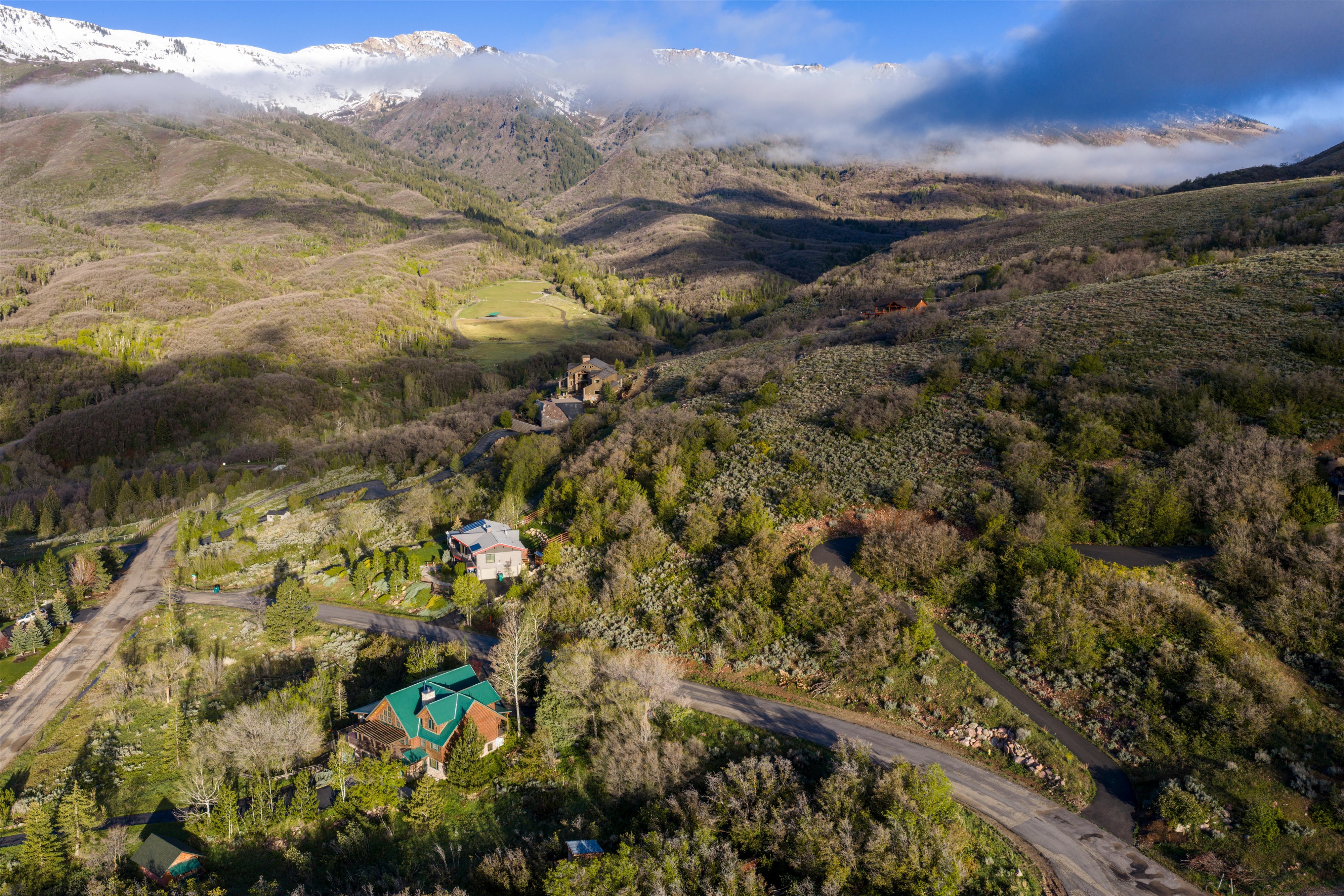 Sweeping aerial perspective highlighting extensive mountainous terrain with snow-capped peaks