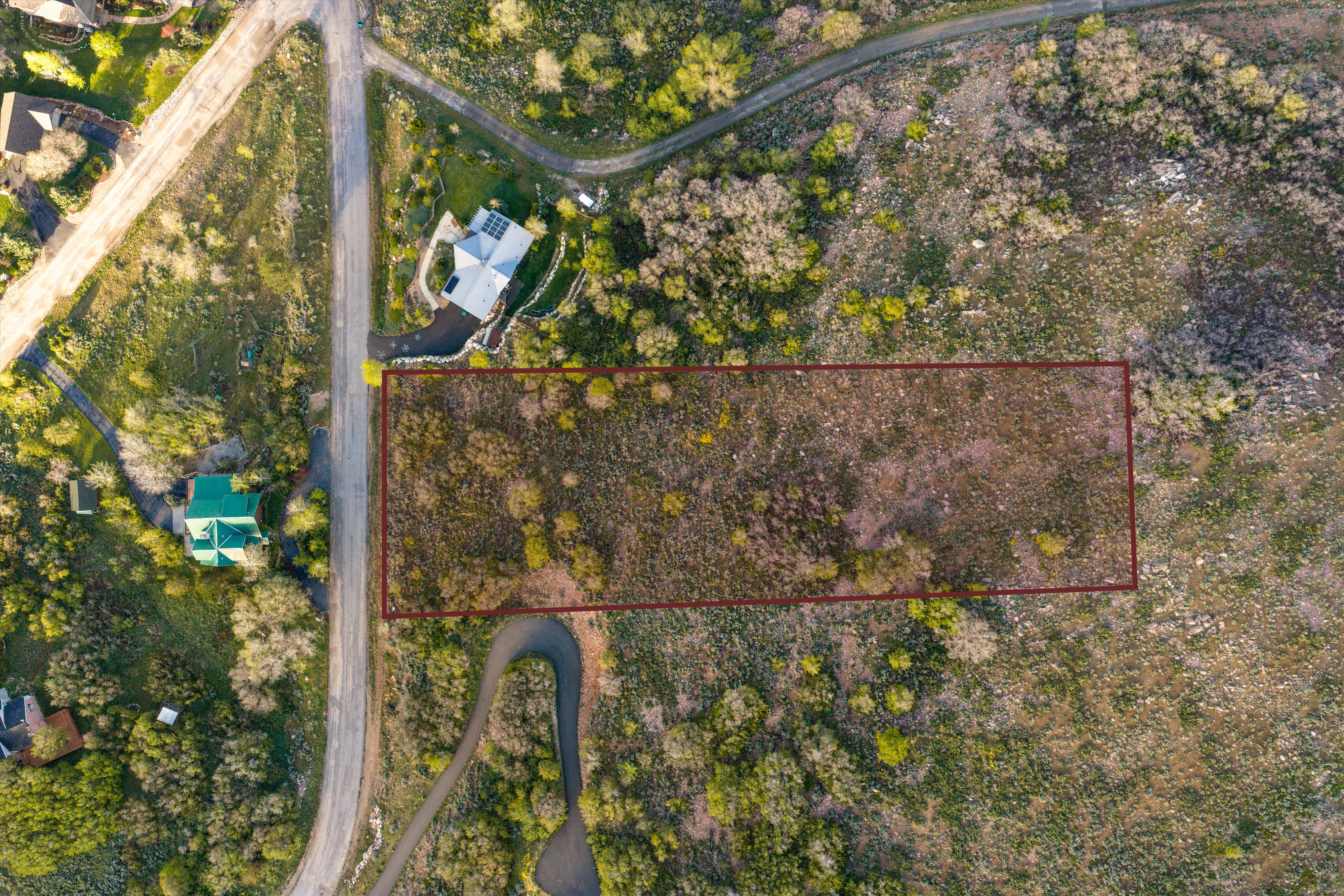 Rectangular parcel of undeveloped land outlined in red