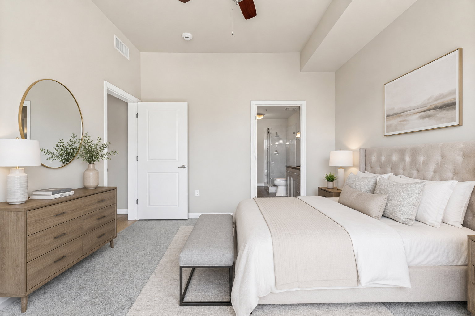 Spacious bedroom featuring light-toned walls, high ceilings, and recessed lighting