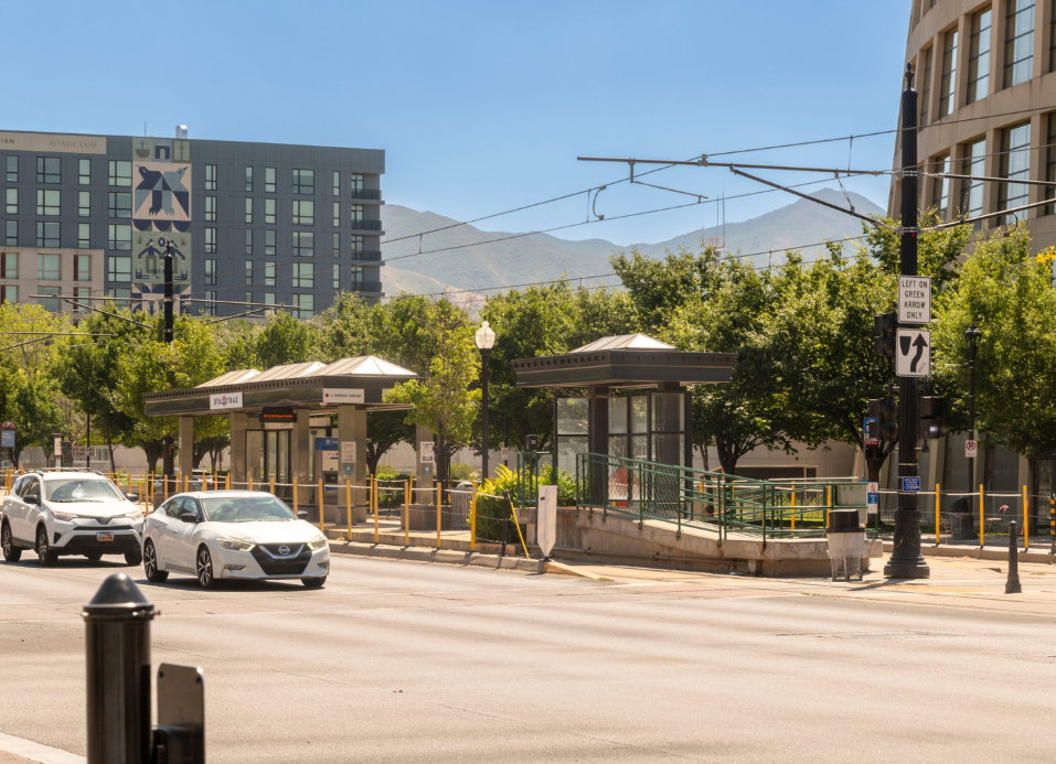 Urban setting featuring a transit stop with covered shelters and a ramp for accessibility