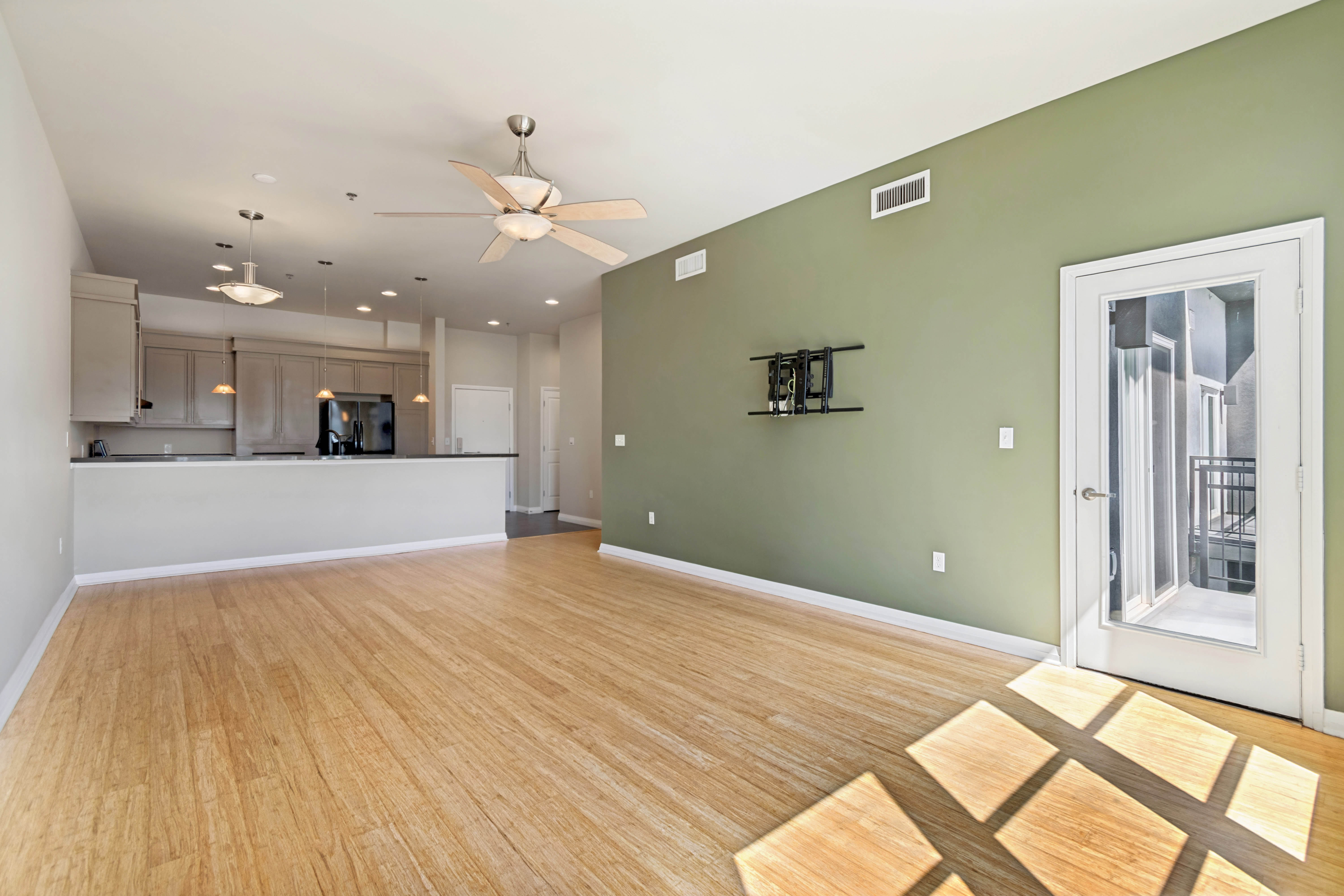 Open-concept living area featuring wood-finish flooring, a contemporary ceiling fan, and recessed lighting