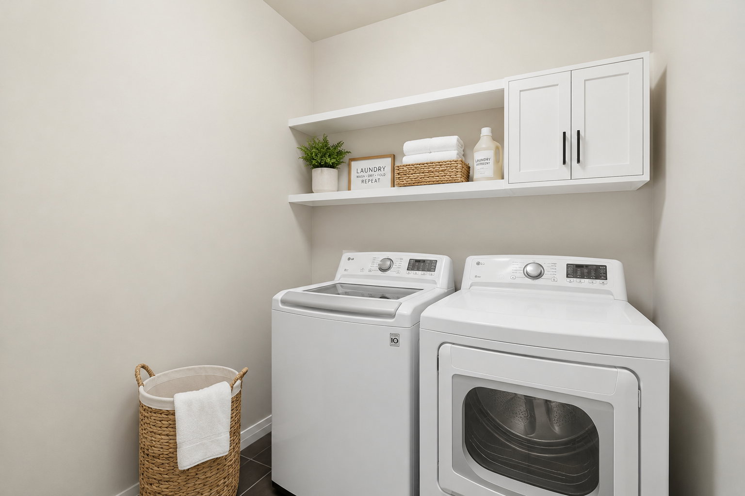Dedicated laundry area featuring a washer and dryer, dark tile flooring, and light-toned walls