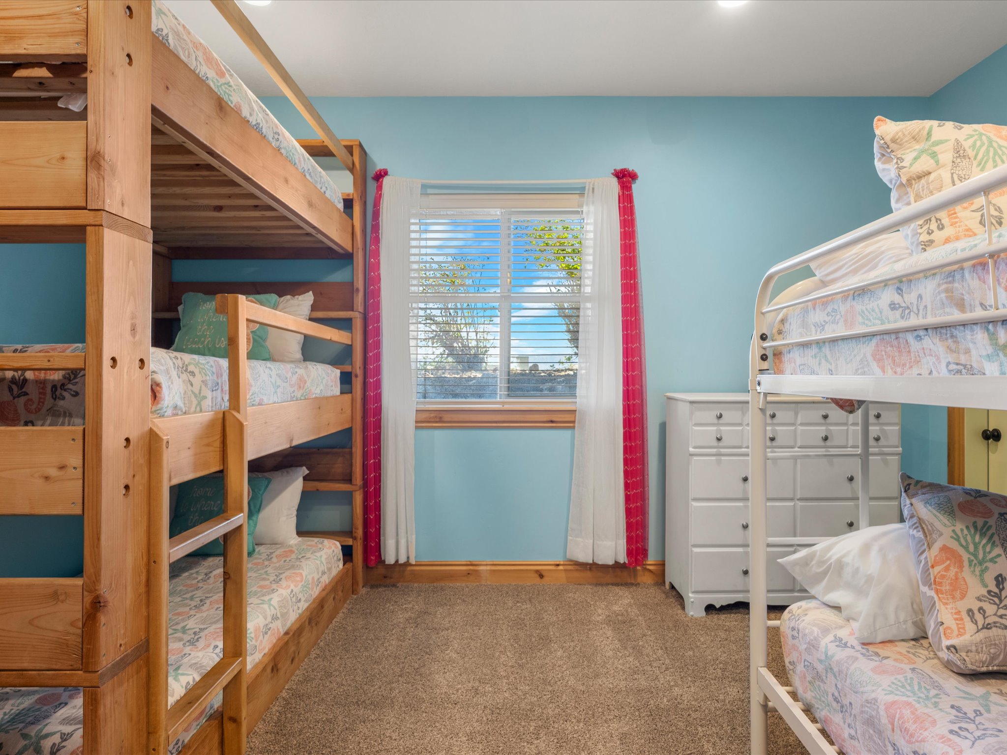 Bedroom with light blue walls and brown carpet flooring